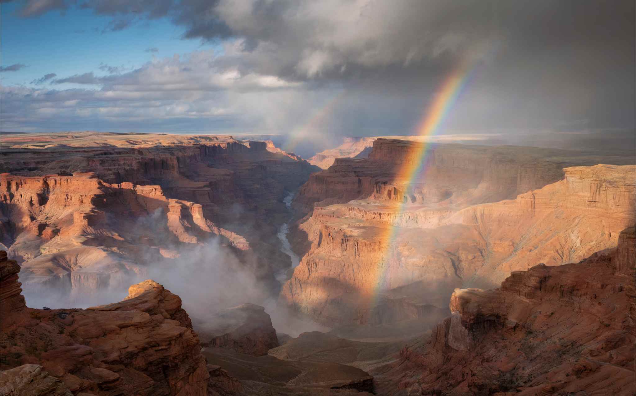 Rainbow Over Dramatic Canyon with Double Arches After Storm (4K) β Free CC0 Stock Photo