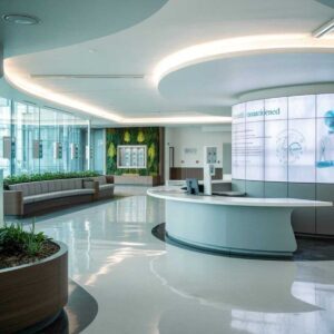 Modern Healthcare Lobby with Reception Desk, Green Wall and Curved Ceiling